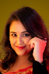 a woman in a red sari posing for a picture